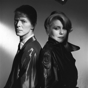 1983 --- British singer and actor David Bowie and French actress Catherine Deneuve on the set of The Hunger, directed by Tony Scott. --- Image by © Metro-Goldwyn-Mayer Pictures/Sunset Boulevard/Corbis